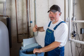 man installing a water softener