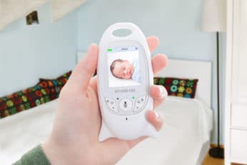 hand holding a white baby monitor