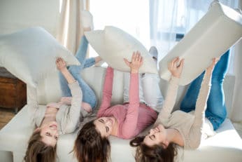 women lying on sofa