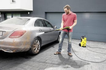 man using the K4 to clean his car