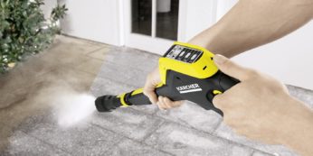 uising a pressure washer to clean concrete floor
