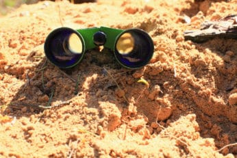 dirty binoculars on the sand