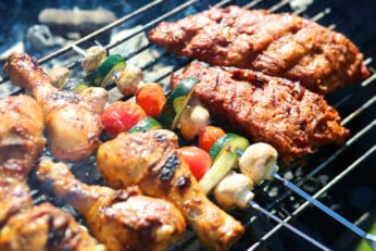 some meat and vegetables on a griller
