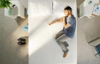 a man sleeping on a simba mattress
