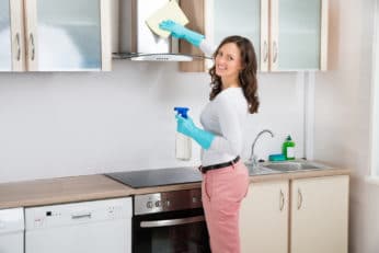 woman cleaning cooker hood