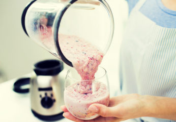 close up of woman with blender and shake at home