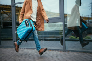 man running with luggage in hand