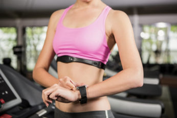 woman using smart watch on treadmill