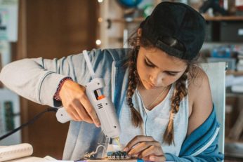 teen using tool that liquefies hot-melt adhesives